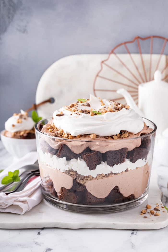 Trifle dish filled with brownie trifle set on a marble countertop.