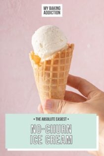 Hand holding up a waffle cone with a scoop of vanilla no-churn ice cream in front of a pink wall. Text overlay includes recipe name.