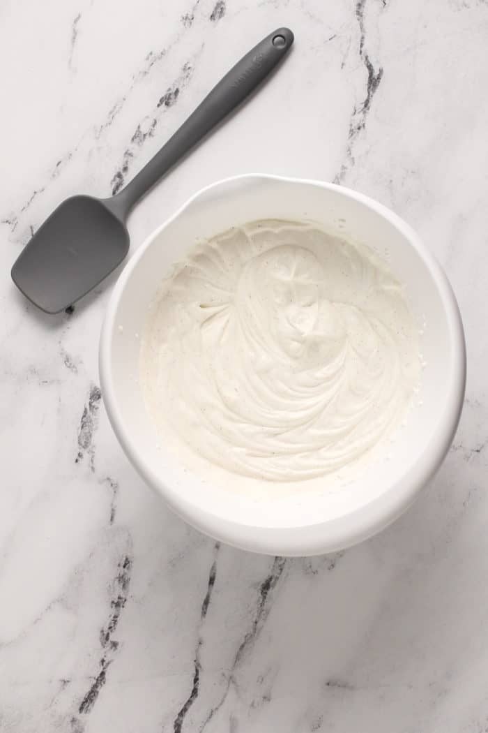 Vanilla no-churn ice cream base in a white mixing bowl.