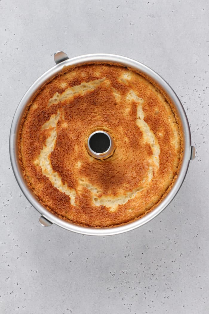 Baked and cooled angel food cake in an angel food cake pan.