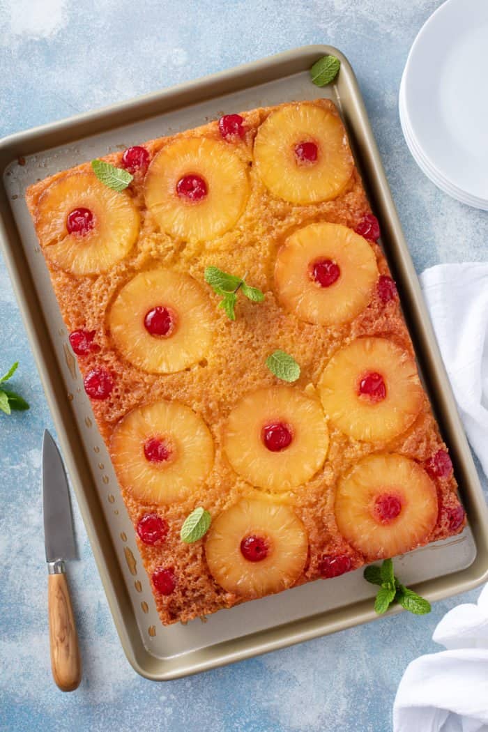 Overhead view of pineapple upside down cake turned out onto a sheet pan.