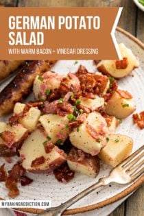 Close up view of german potato salad on a plate. Two brats are just visible off to the side of the salad. Text overlay includes recipe name.