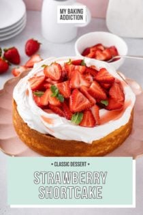 Strawberry shortcake topped with whipped cream and sliced strawberries on a pink cake plate. Text overlay includes recipe name.