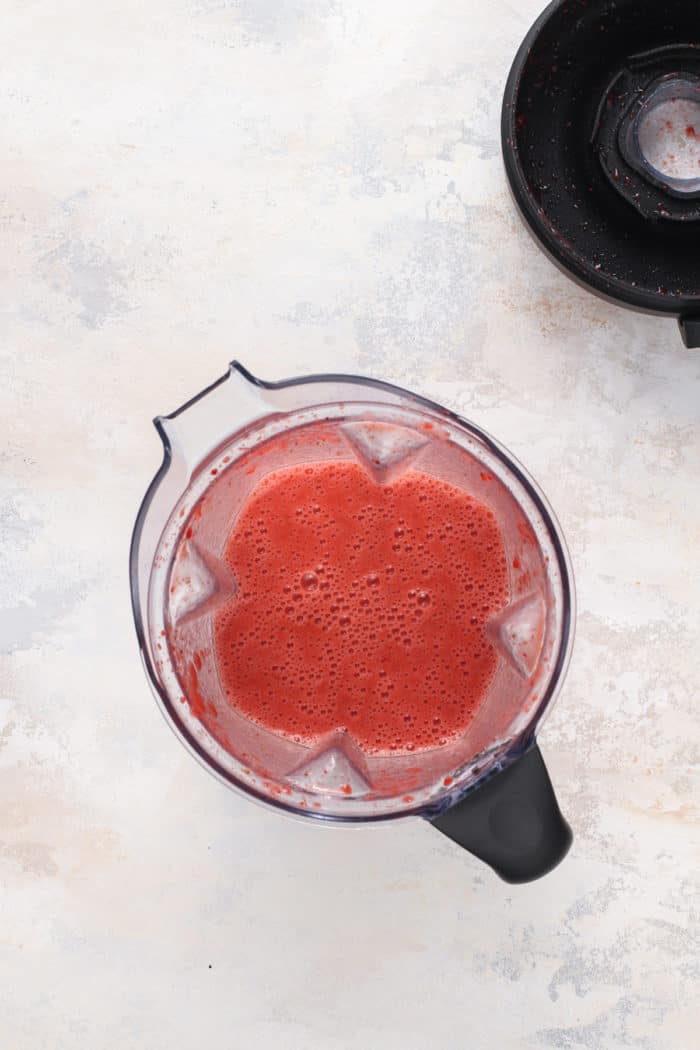 Strawberry puree for pie filling in a blender jar.