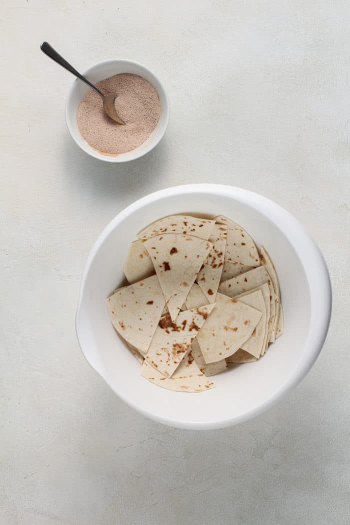 Flour tortilla wedges tossed with butter in a white bowl.