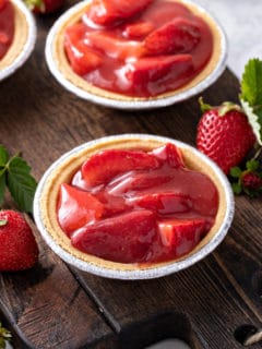 Mini graham cracker crusts filled with strawberry pie filling.