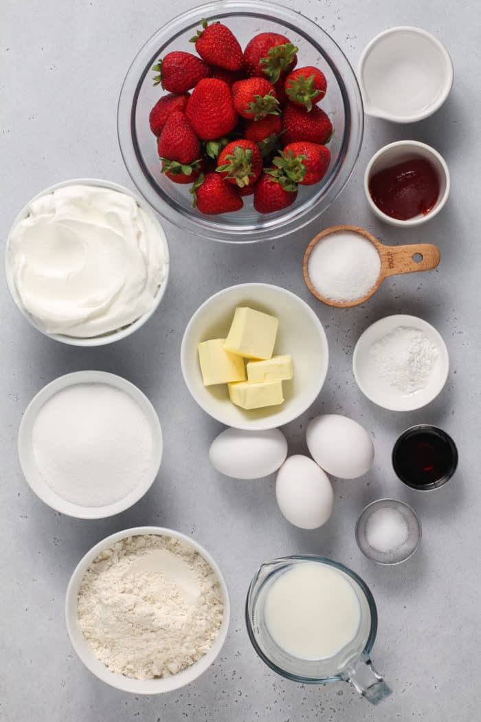 Strawberry shortcake ingredients arranged on a gray countertop.