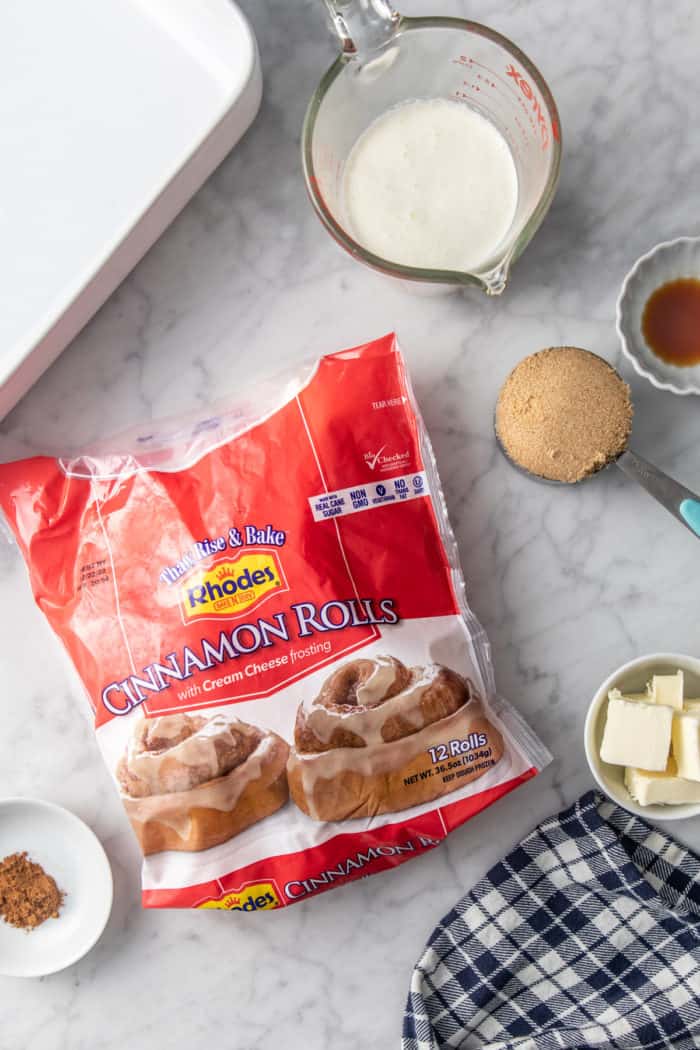 Ingredients for tiktok cinnamon rolls, aka cinnamon rolls with heavy cream, arranged on a marble countertop.