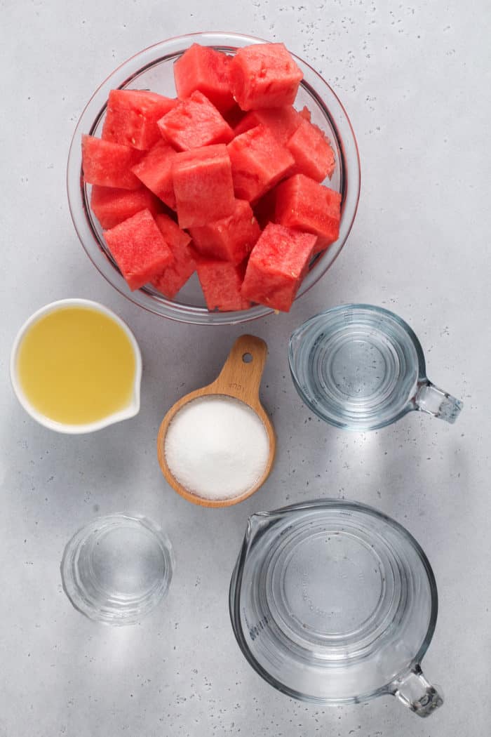 Watermelon lemonade ingredients arranged on a gray countertop.