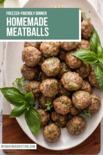 Overhead view of a white oval platter filled with baked homemade meatballs. Text overlay includes recipe name.