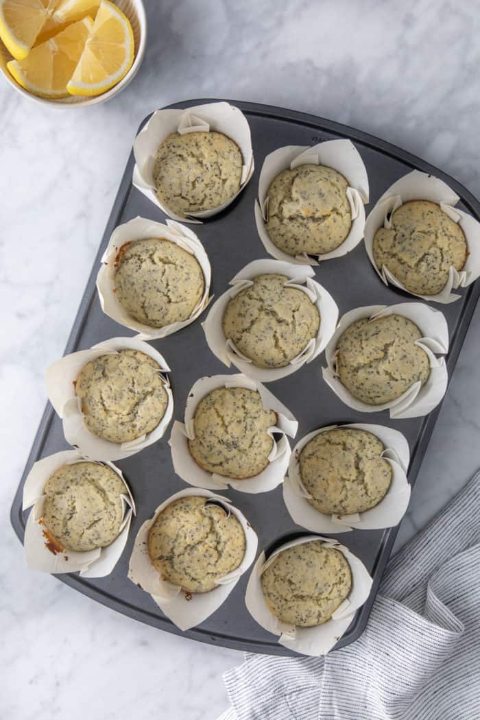 Overhead view of baked lemon poppy seed muffins in a muffin tin.