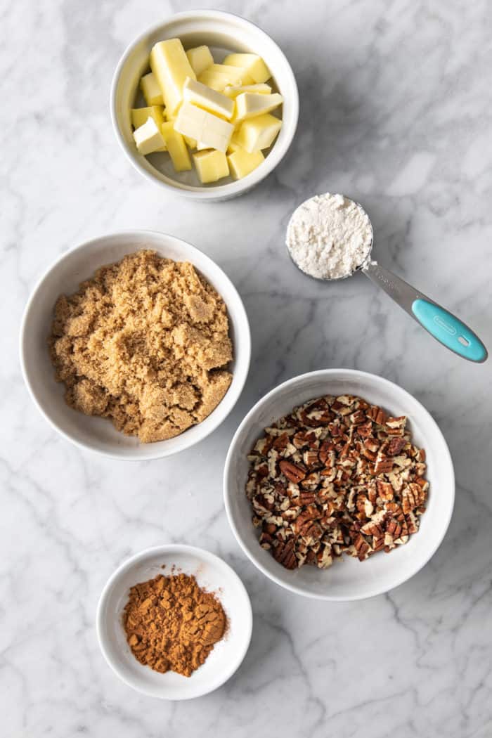 Easy coffee cake streusel ingredients arranged on a marble countertop.