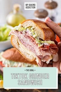 Hand holding up half of a tiktok grinder sandwich. Text overlay includes recipe name.