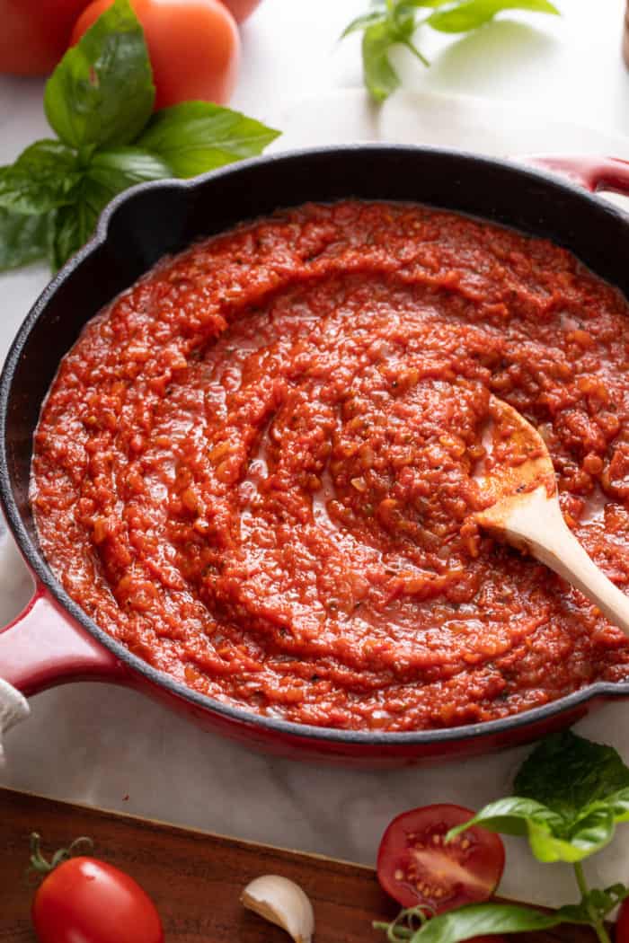 Close up of quick marinara sauce being stirred in a skillet.