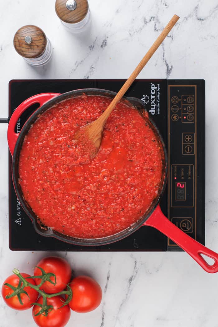 Quick marinara sauce being simmered in a cast iron skillet.