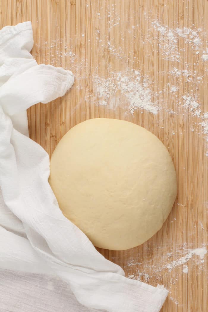 Dough for strawberry rolls set on a lightly floured work surface.