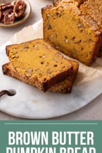 Loaf of brown butter pumpkin bread with several slices cut from it set on a marble board. Text overlay includes recipe name.