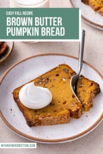 Fork cutting into a slice of brown butter pumpkin bread, topped with whipped cream, on a cream plate. Text overlay includes recipe name.