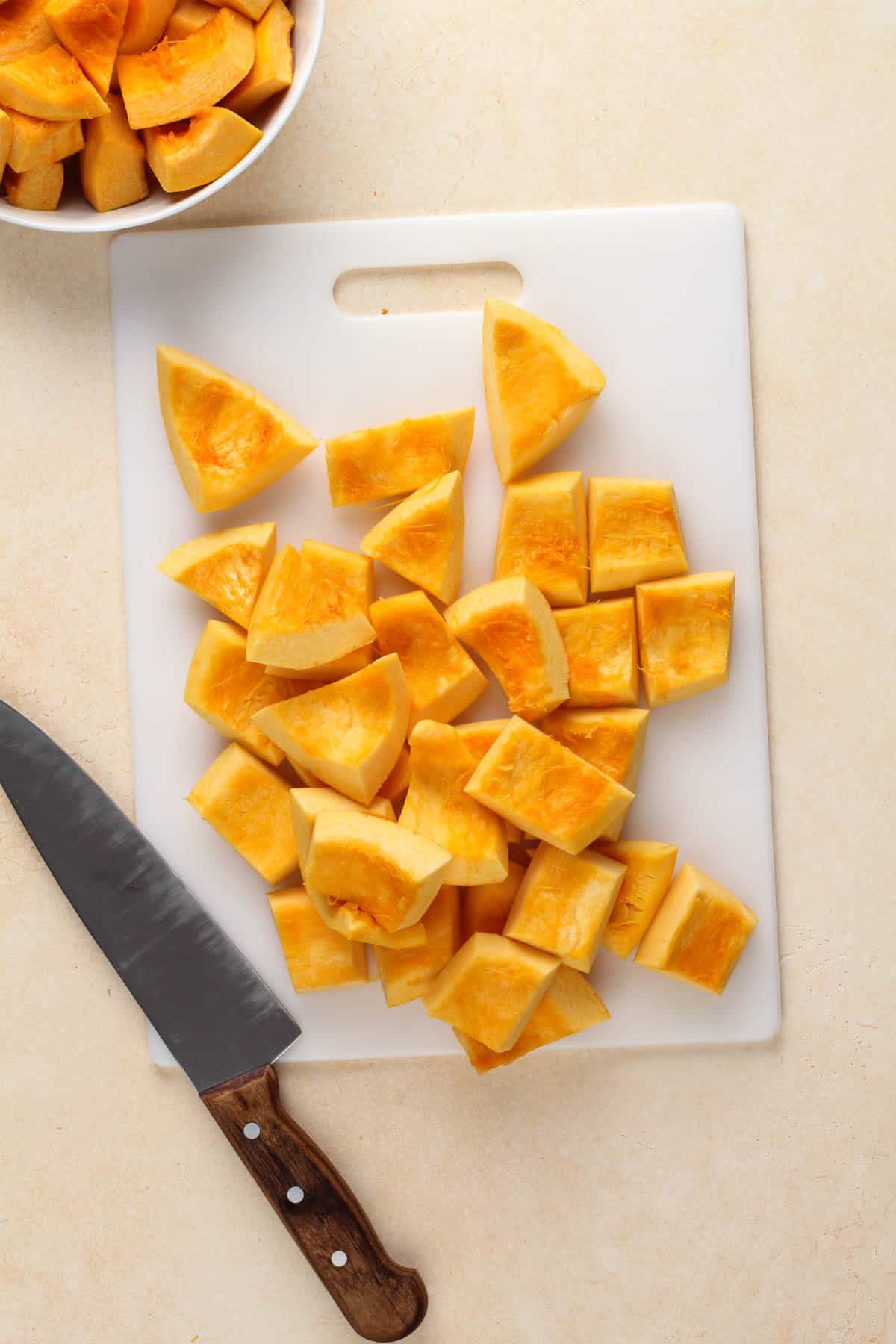 a knife and cut pumpkin on a cutting board