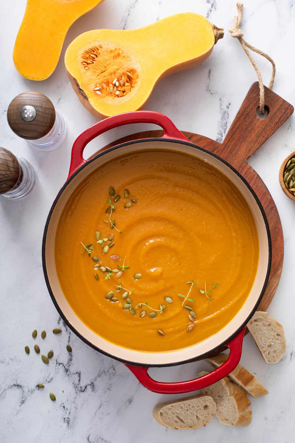 a red stock pot of butternut squash soup