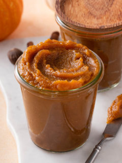 two pumpkin butter jars on white tray