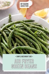 Lemon being squeezed over air fryer green beans in a white serving bowl. Text overlay includes recipe name.