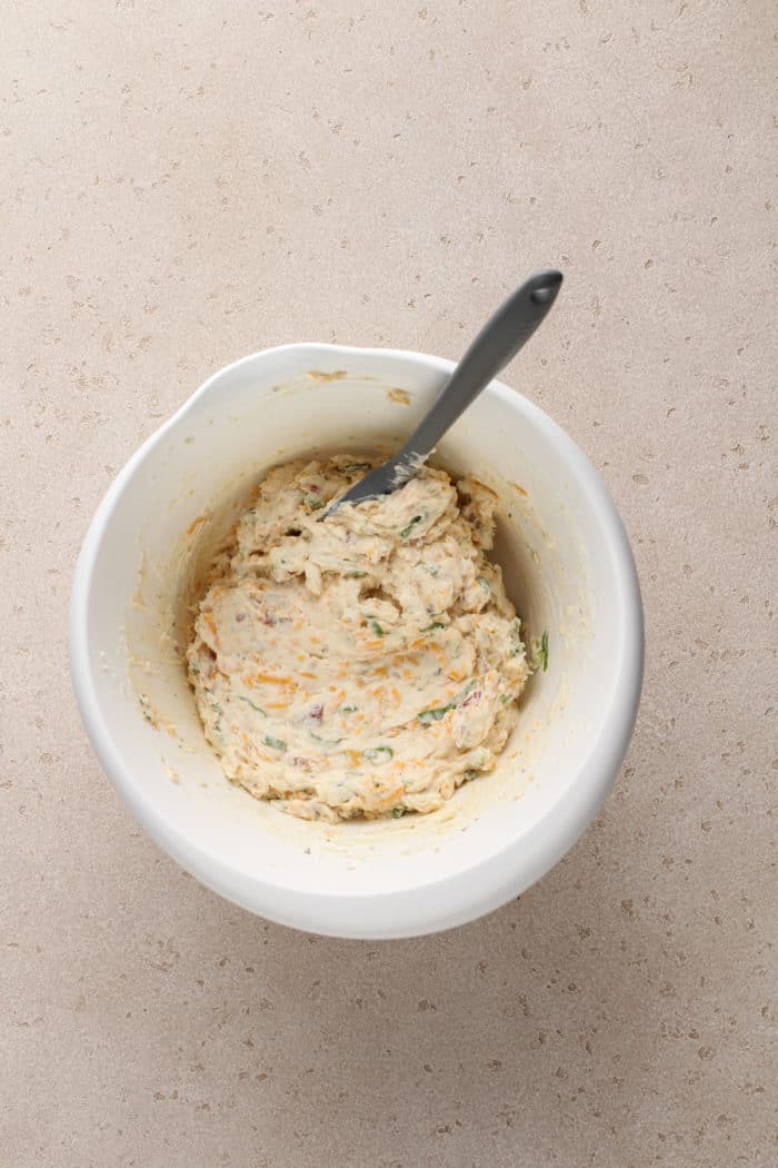 Base for bacon ranch cheese ball being mixed in a white bowl.