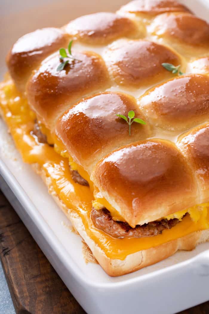 Baked breakfast sliders in a white baking dish.