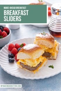 Two breakfast sliders on a white plate next to mixed berries. Text overlay includes recipe name.