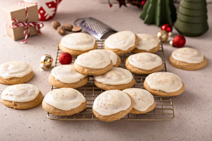 Wire rack filled with iced eggnog cookies.