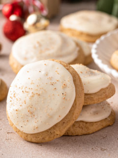 Two stacked eggnog cookies with a third cookie leaning against the stack.