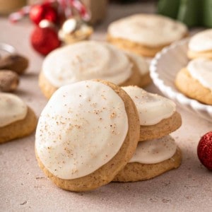 Two stacked eggnog cookies with a third cookie leaning against the stack.