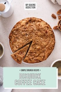 Slice cut from a bisquick coffee cake, set on a beige countertop with cups of coffee. Text overlay includes recipe name.