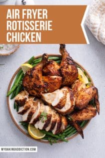 Carved air fryer rotisserie chicken on a platter with green beans and lemon wedges. Text overlay includes recipe name.