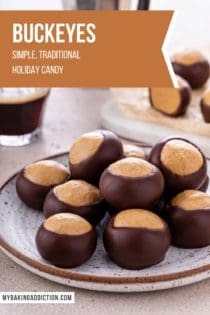 Buckeye candies piled onto a pottery plate. A cup of espresso and more buckeyes are visible in the background. Text overlay includes recipe name.