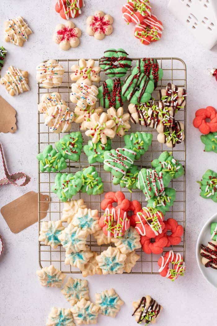 Overhead view of assorted spritz cookies on a wire cooling rack.