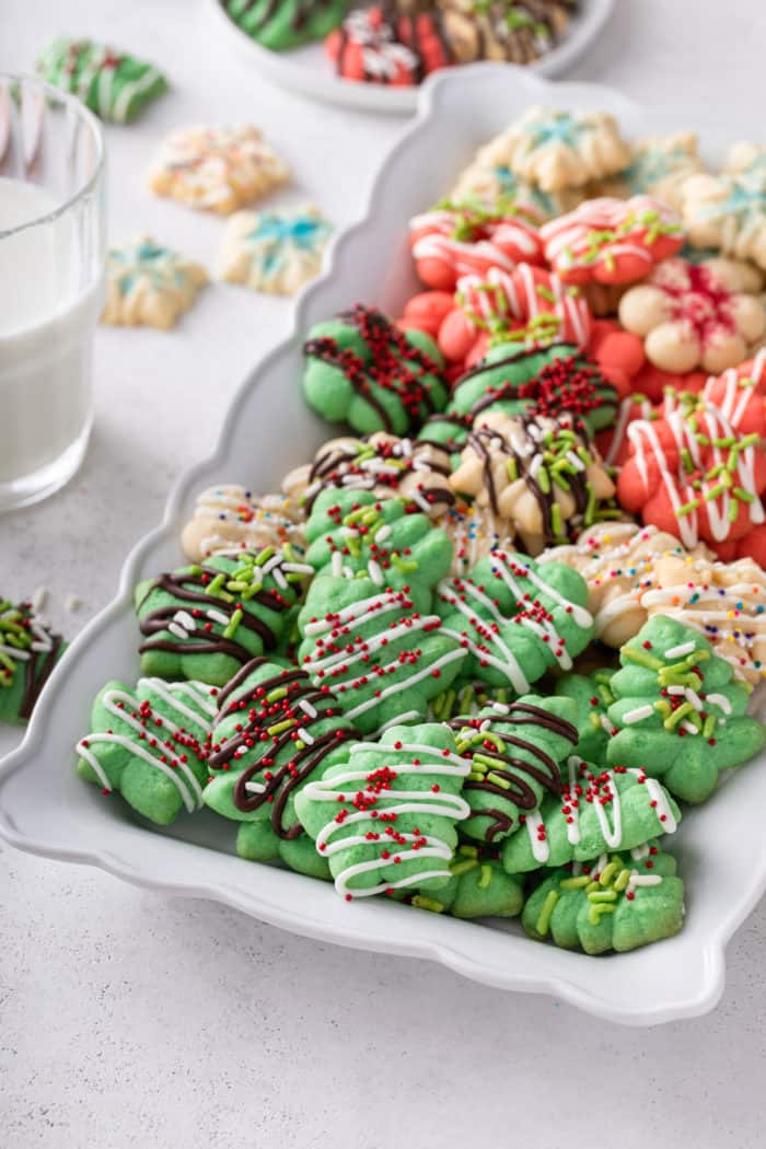 White platter filled with christmas-themed spritz cookies.