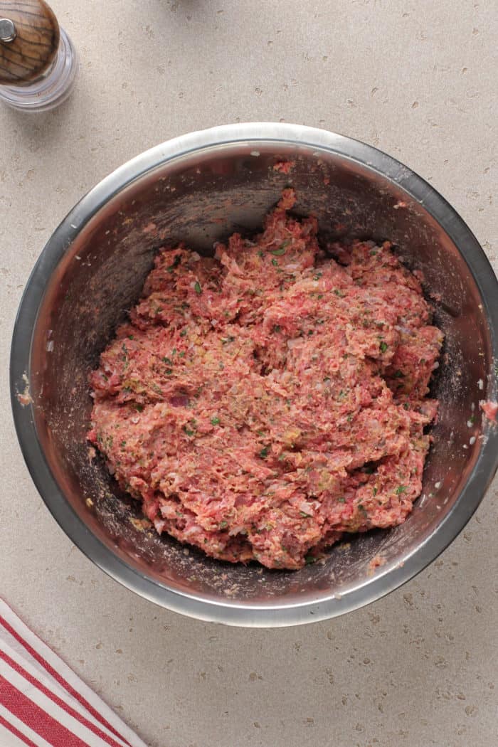 Mix for air fryer meatballs in a metal mixing bowl.