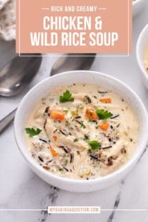 Close up view of chicken and wild rice soup in a white bowl on a marble countertop. Text overlay includes recipe name.