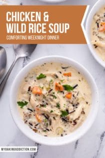 Overhead shot of a bowl of chicken and wild rice soup on a marble countertop, set next to two spoons. Text overlay includes recipe name.