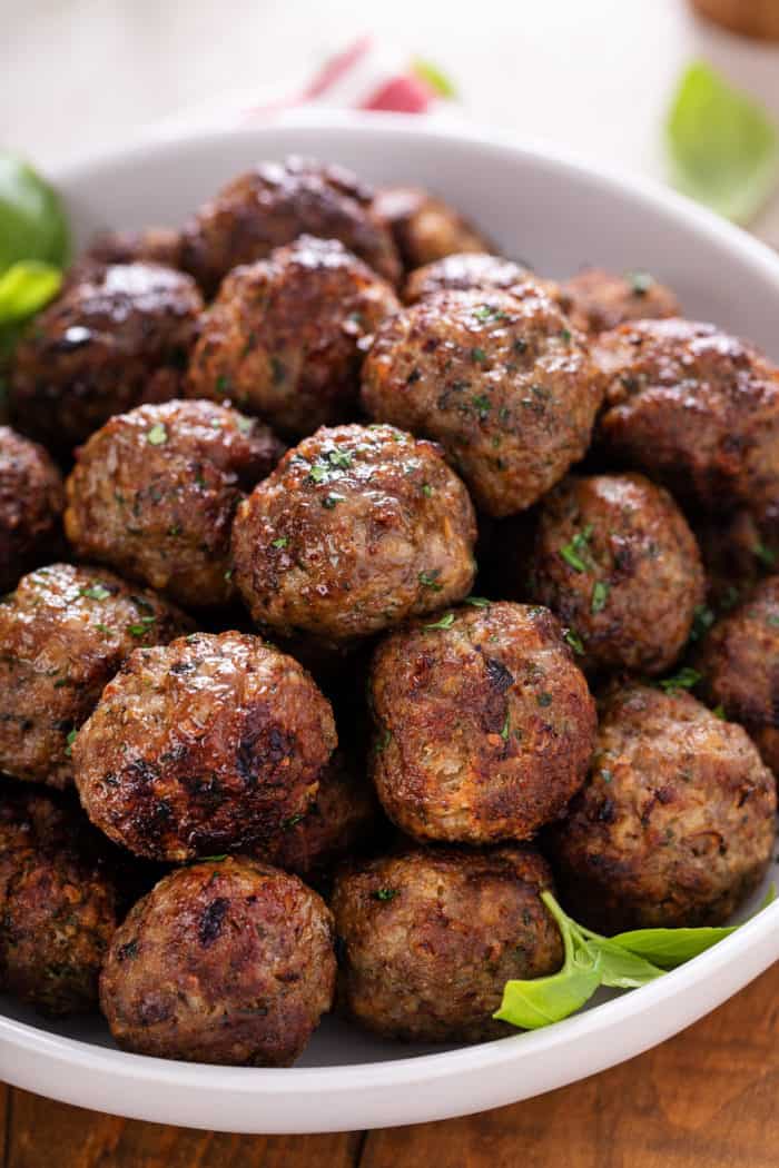 Close up of air fryer meatballs in a white bowl.