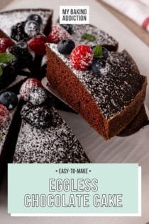 Cake server lifting a slice of eggless chocolate cake off of a cake plate. Text overlay includes recipe name.