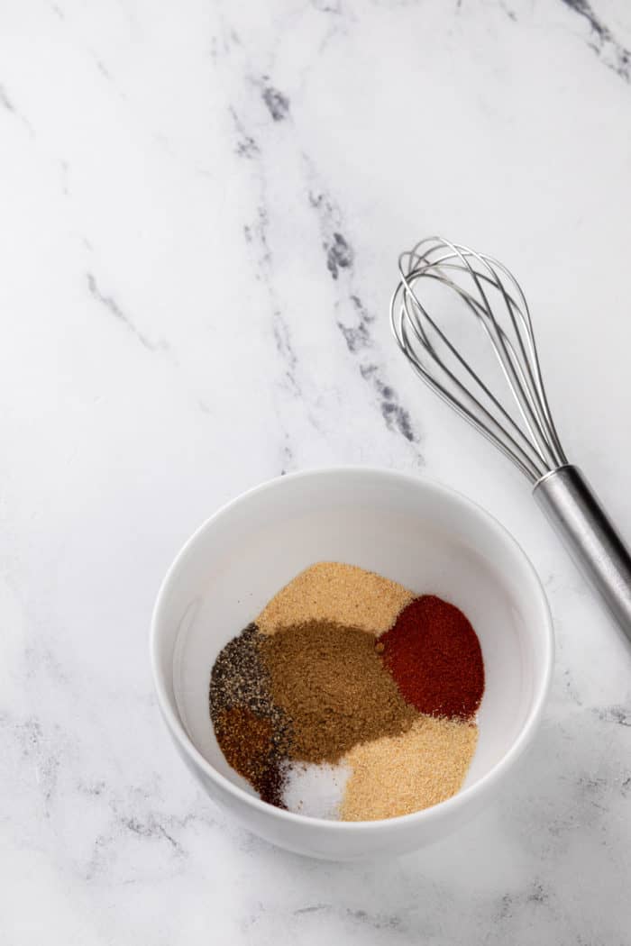 Small bowl of fajita spices about to be whisked together.