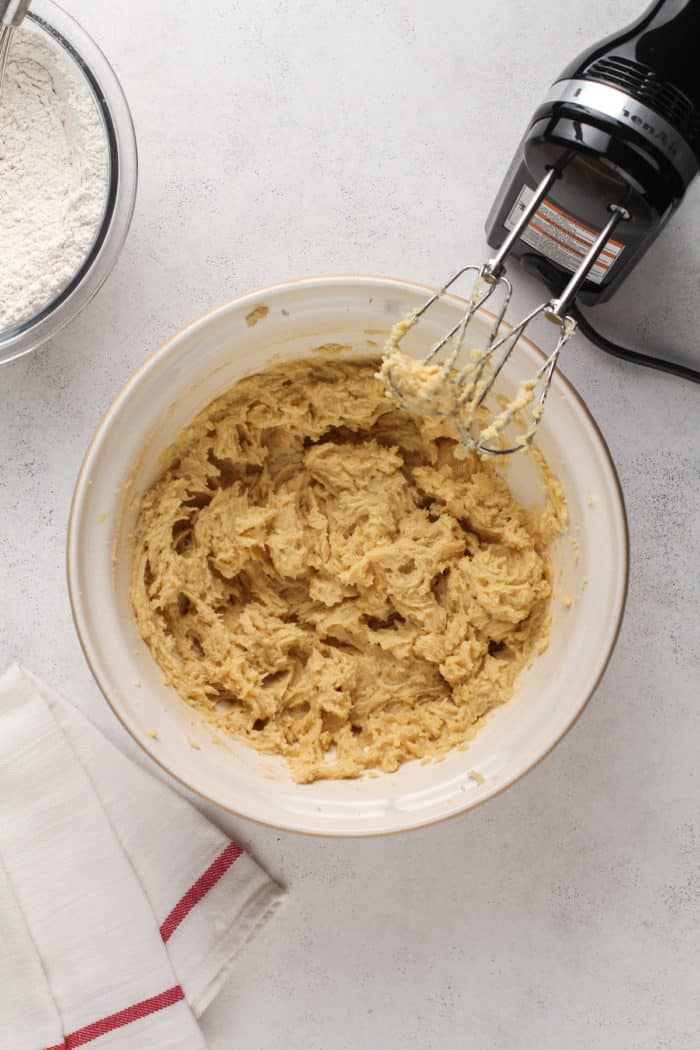 Cookie dough base for kitchen sink cookies being mixed in a ceramic bowl.