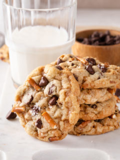 Three stacked kitchen sink cookies with a fourth cookie leaning agains the stack.