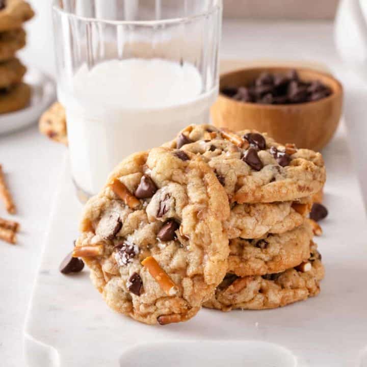 Three stacked kitchen sink cookies with a fourth cookie leaning agains the stack.