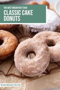 Close up of assorted cake donuts arranged on a wire rack. Text overlay includes recipe name.