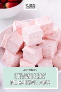 White bowl filled with strawberry marshmallows. A bowl of sliced strawberries is in the background. Text overlay includes recipe name.