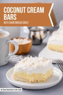 Plated coconut cream bar with cups of coffee in the background. A bite has been taken from the corner of the bar. Text overlay includes recipe name.