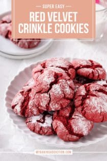 White plate filled with red velvet crinkle cookies. A glass of milk is visible in the background. Text overlay includes recipe name.